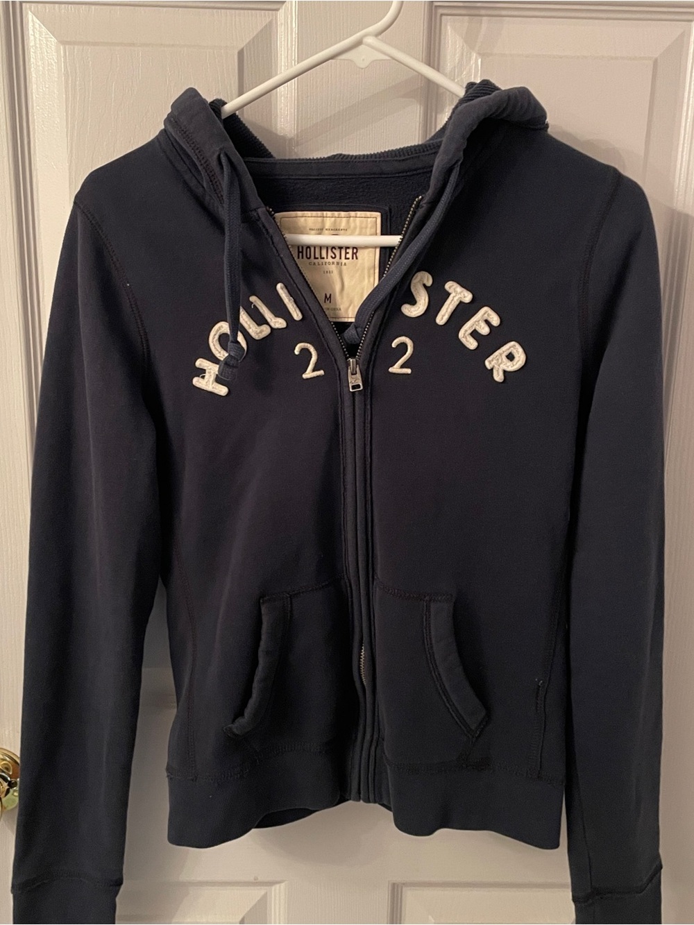 Hollister Navy Zip-Up Hoodie with White Lettering junior size.